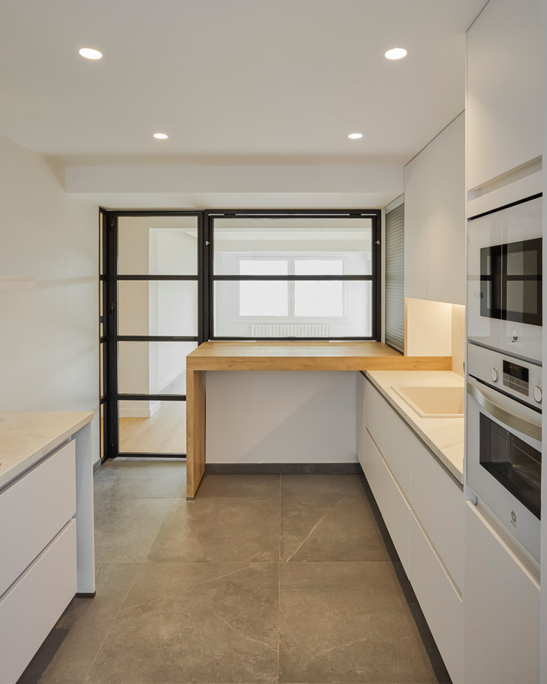Photo of a mid-sized modern single-wall eat-in kitchen in Other with a single-bowl sink, shaker cabinets, white cabinets, quartz benchtops, white splashback, engineered quartz splashback, white appliances, porcelain floors, no island, grey floor and white benchtop.