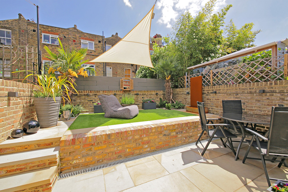 This is an example of a modern backyard full sun garden in Other.