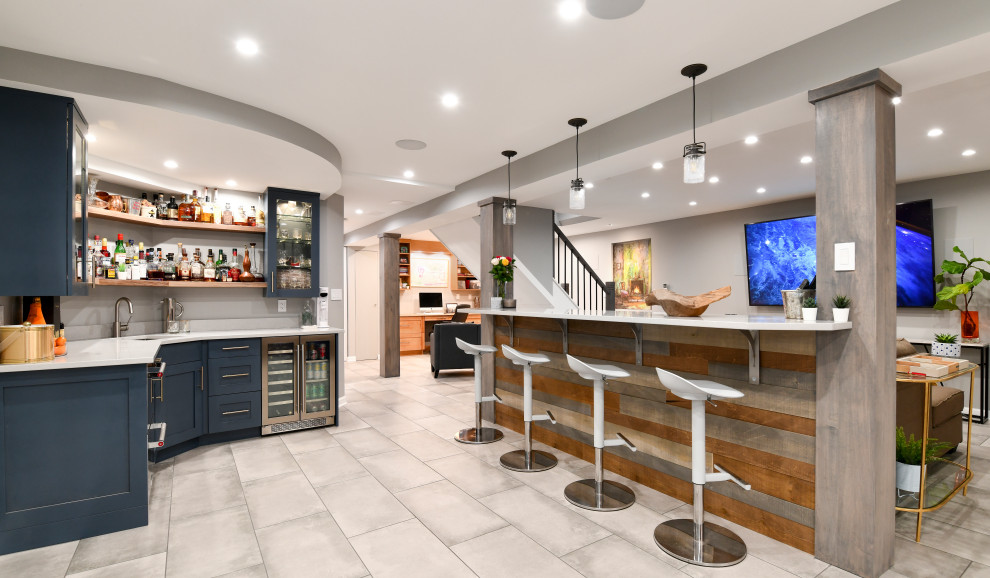 Large transitional porcelain tile and gray floor basement photo in DC Metro with a bar, gray walls, a standard fireplace and a brick fireplace