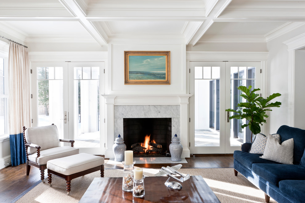 Photo of a beach style formal enclosed living room in DC Metro with white walls, dark hardwood floors, a standard fireplace, a stone fireplace surround and no tv.