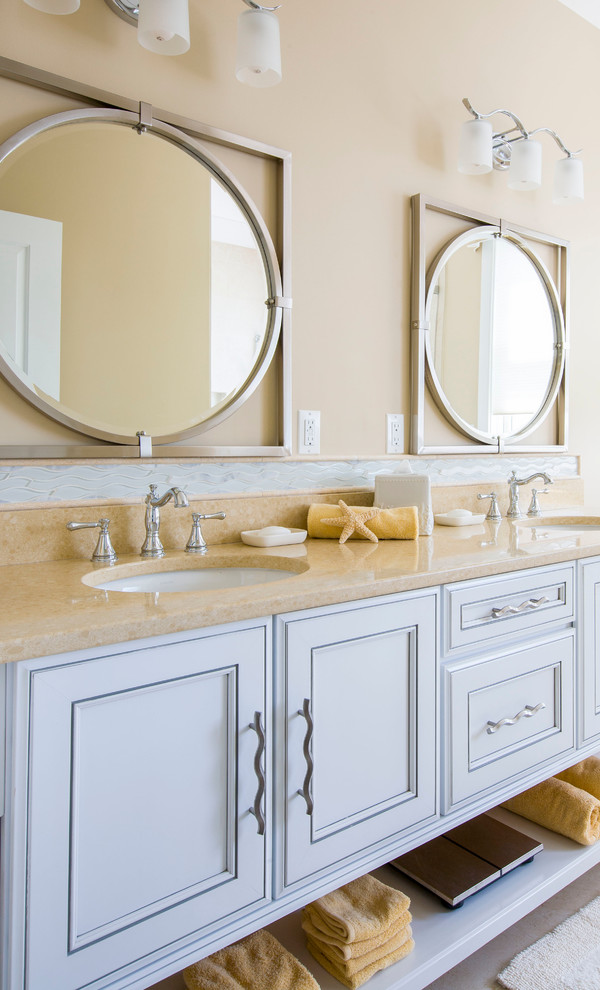 Design ideas for a beach style bathroom in Baltimore with an undermount sink, beaded inset cabinets, grey cabinets, beige walls and limestone benchtops.