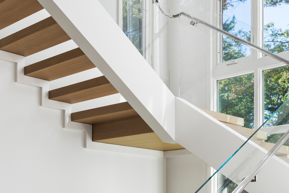Large modern wood u-shaped staircase in Boston with open risers.