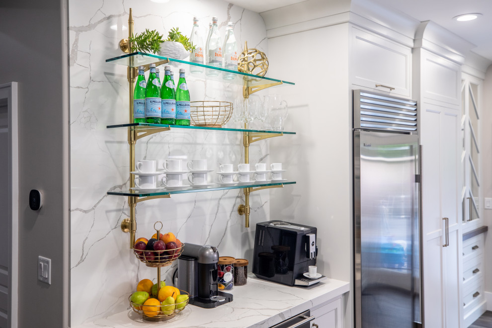 Eat-in kitchen - transitional medium tone wood floor and brown floor eat-in kitchen idea with a farmhouse sink, shaker cabinets, white cabinets, quartz countertops, white backsplash, quartz backsplash, stainless steel appliances, two islands and white countertops