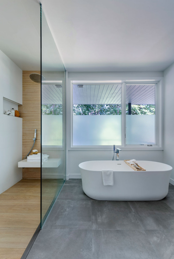 Inspiration for a mid-sized midcentury master bathroom in Boston with white benchtops, a freestanding tub, an open shower, multi-coloured walls, medium hardwood floors, multi-coloured floor, an open shower and a single vanity.