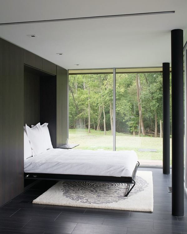 Photo of a large modern master bedroom in Kansas City with white walls, dark hardwood floors and no fireplace.