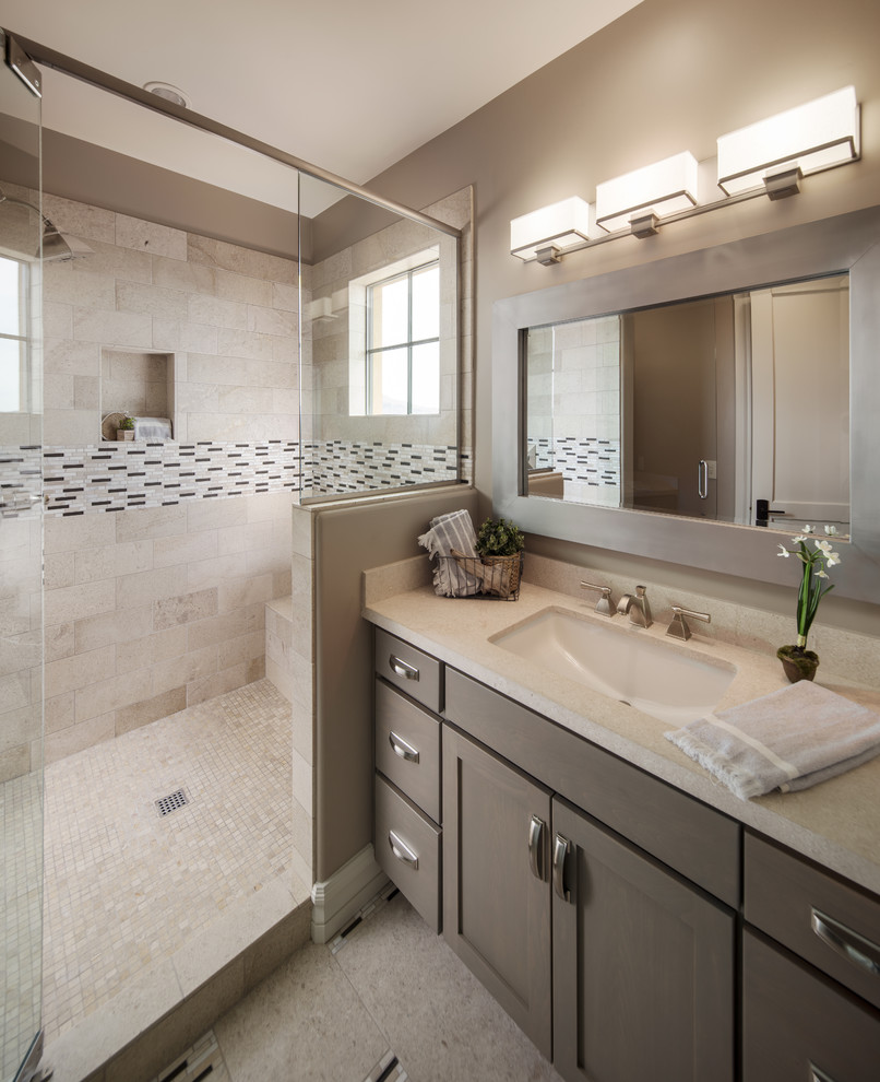 Design ideas for a transitional bathroom in Phoenix with medium wood cabinets, beige walls, limestone floors and limestone benchtops.