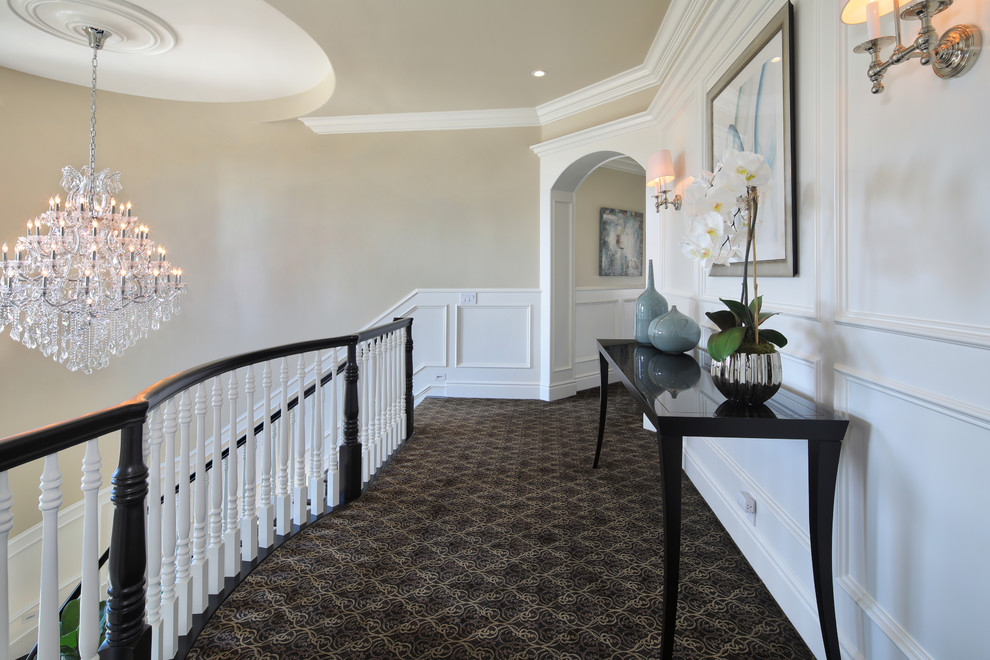 Photo of a mid-sized transitional hallway in Orange County with beige walls, carpet and brown floor.