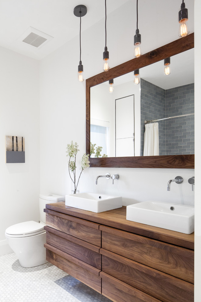 Photo of a contemporary master bathroom in Toronto with flat-panel cabinets, dark wood cabinets, white walls, mosaic tile floors, a vessel sink, wood benchtops and brown benchtops.