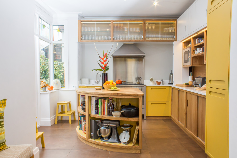 Large midcentury l-shaped kitchen in Manchester with an integrated sink, flat-panel cabinets, yellow cabinets, quartz benchtops, stainless steel appliances, porcelain floors, with island, brown floor and grey splashback.