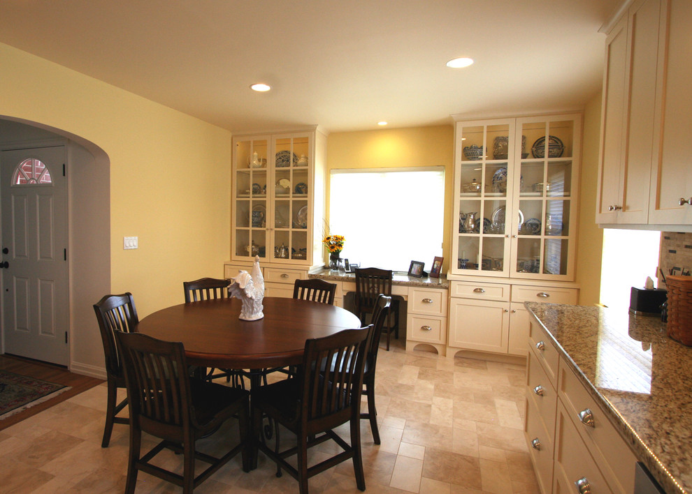 Eat-in kitchen - mid-sized transitional single-wall ceramic tile eat-in kitchen idea with an undermount sink, shaker cabinets, white cabinets, granite countertops, beige backsplash, stone tile backsplash, stainless steel appliances and no island