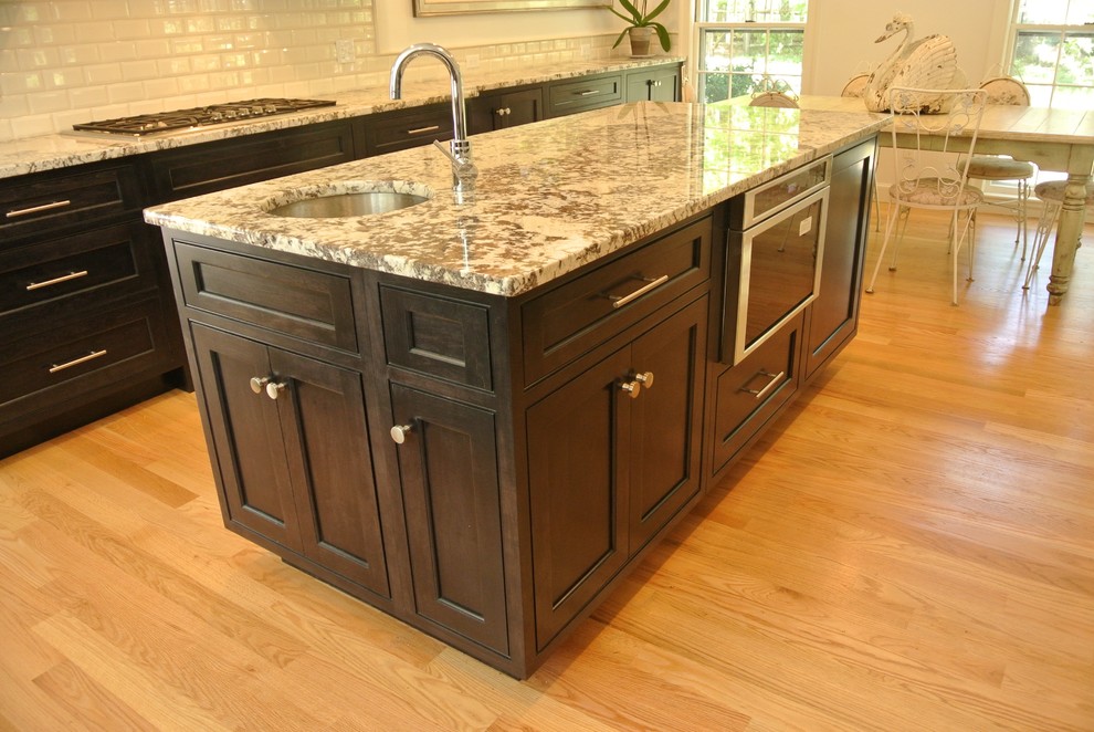 Eat-in kitchen - transitional light wood floor eat-in kitchen idea in Boston with an undermount sink, shaker cabinets, granite countertops, white backsplash, subway tile backsplash, stainless steel appliances and an island