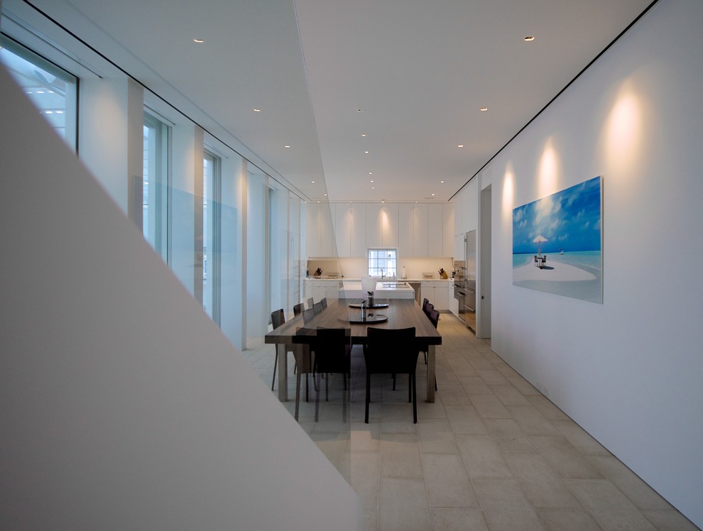 Photo of an expansive contemporary separate dining room in DC Metro with white walls and limestone floors.