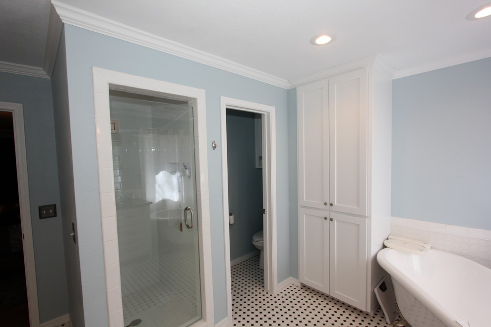 Inspiration for a mid-sized traditional master bathroom in Other with recessed-panel cabinets, white cabinets, a claw-foot tub, an alcove shower, ceramic tile, blue walls, ceramic floors, an undermount sink, marble benchtops, white tile, white floor and a hinged shower door.
