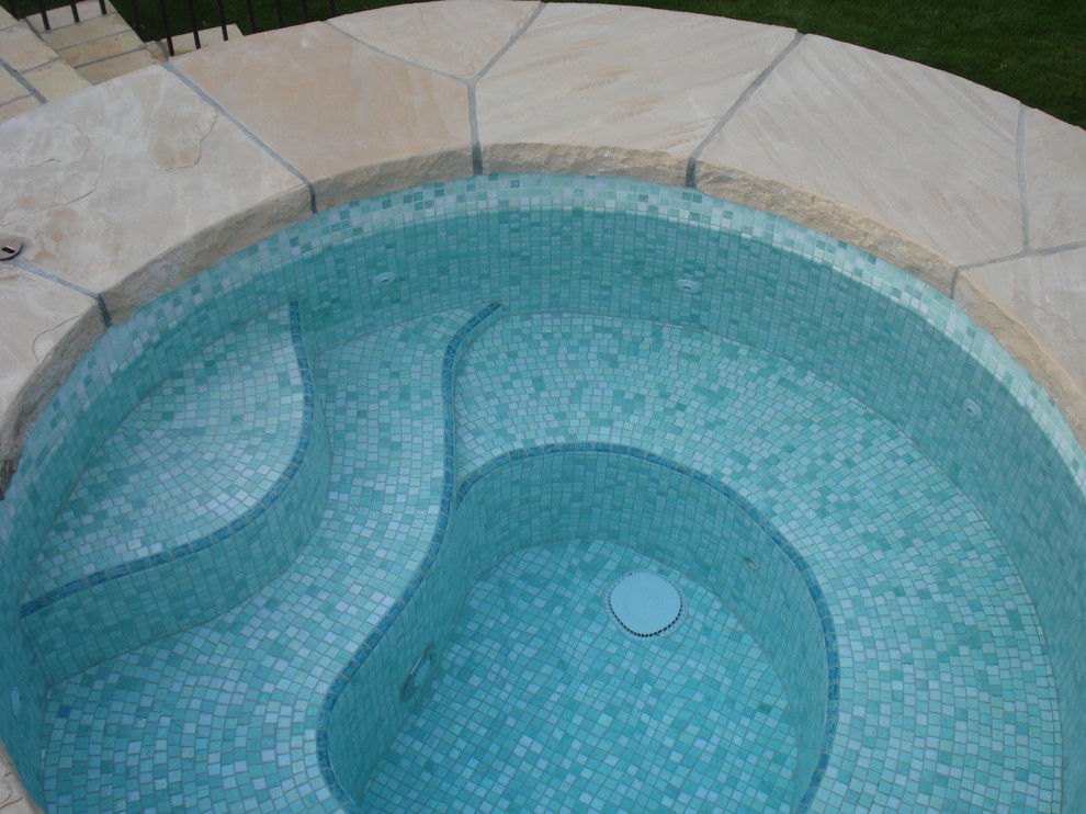 This is an example of a mid-sized mediterranean backyard rectangular lap pool in Phoenix with a hot tub and tile.