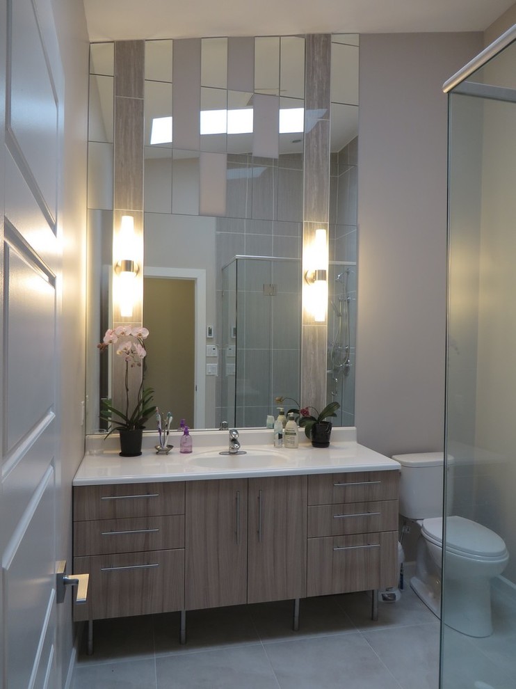 This is an example of a mid-sized contemporary master bathroom in Vancouver with an integrated sink, flat-panel cabinets, beige cabinets, engineered quartz benchtops, an alcove shower, a two-piece toilet, beige tile, ceramic tile, beige walls and ceramic floors.