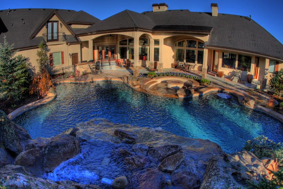 Inspiration for a large transitional backyard stone and custom-shaped aboveground pool fountain remodel in Boise
