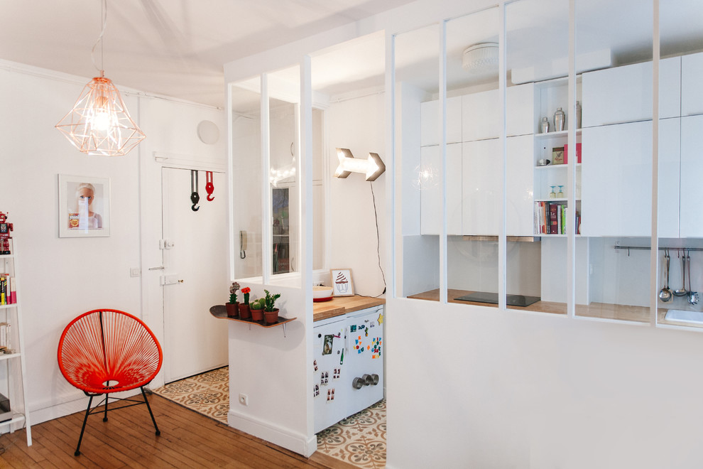 Design ideas for a mid-sized scandinavian kitchen in Paris with medium hardwood floors.