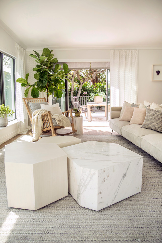 Example of a large danish open concept porcelain tile and beige floor family room design in Miami with white walls and no fireplace