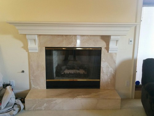 How would you fix this fireplace mantel? Need help ASAP please!! We added the mantel and corbels to this fireplace. We debated where to put the corbels. I don