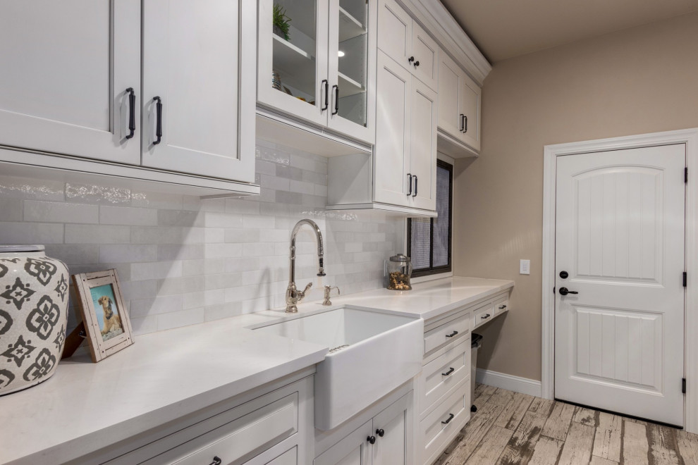 Inspiration for a country laundry room in Phoenix with shaker cabinets, white cabinets, white splashback, subway tile splashback, a side-by-side washer and dryer and white benchtop.