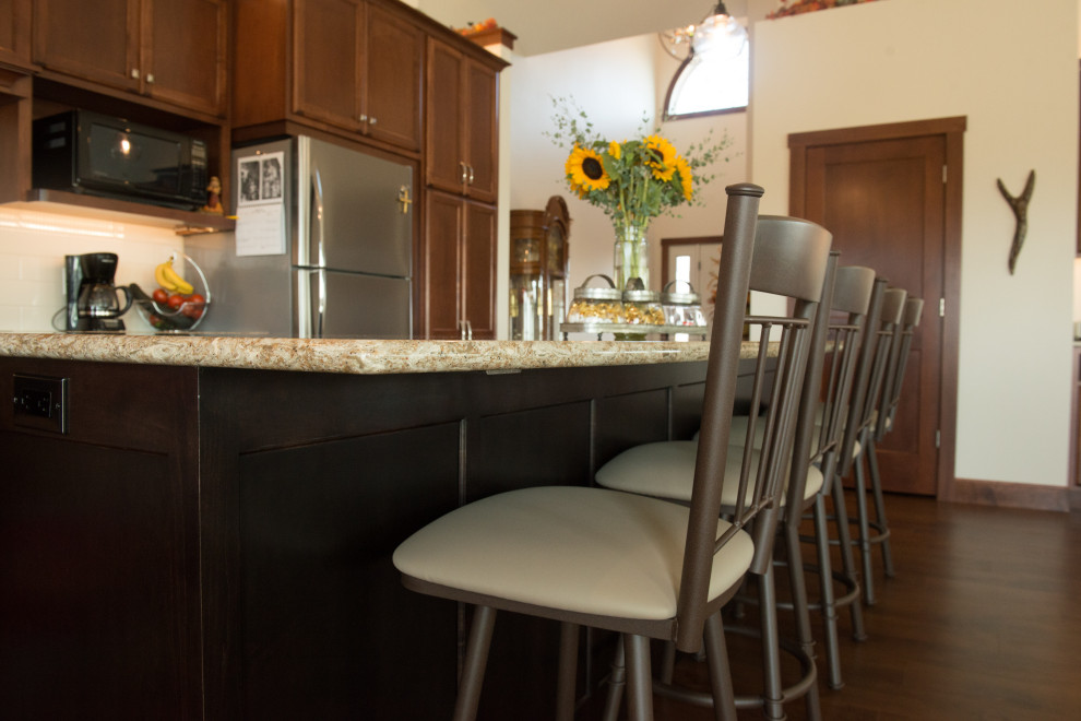 Example of a large transitional l-shaped medium tone wood floor open concept kitchen design with an undermount sink, flat-panel cabinets, medium tone wood cabinets, quartz countertops, white backsplash, ceramic backsplash, stainless steel appliances, an island and multicolored countertops