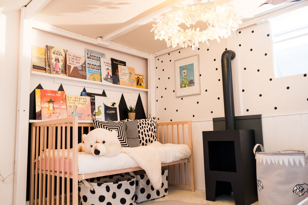 Photo of a mid-sized contemporary gender-neutral kids' bedroom for kids 4-10 years old in Other with painted wood floors, white floor and grey walls.