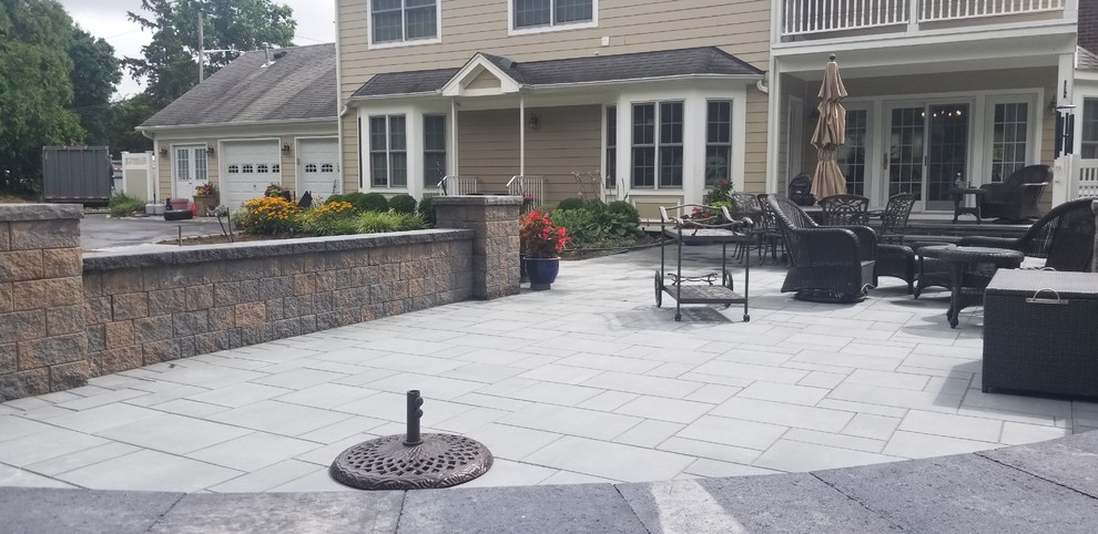 Design ideas for a mid-sized backyard patio in New York with concrete pavers and no cover.