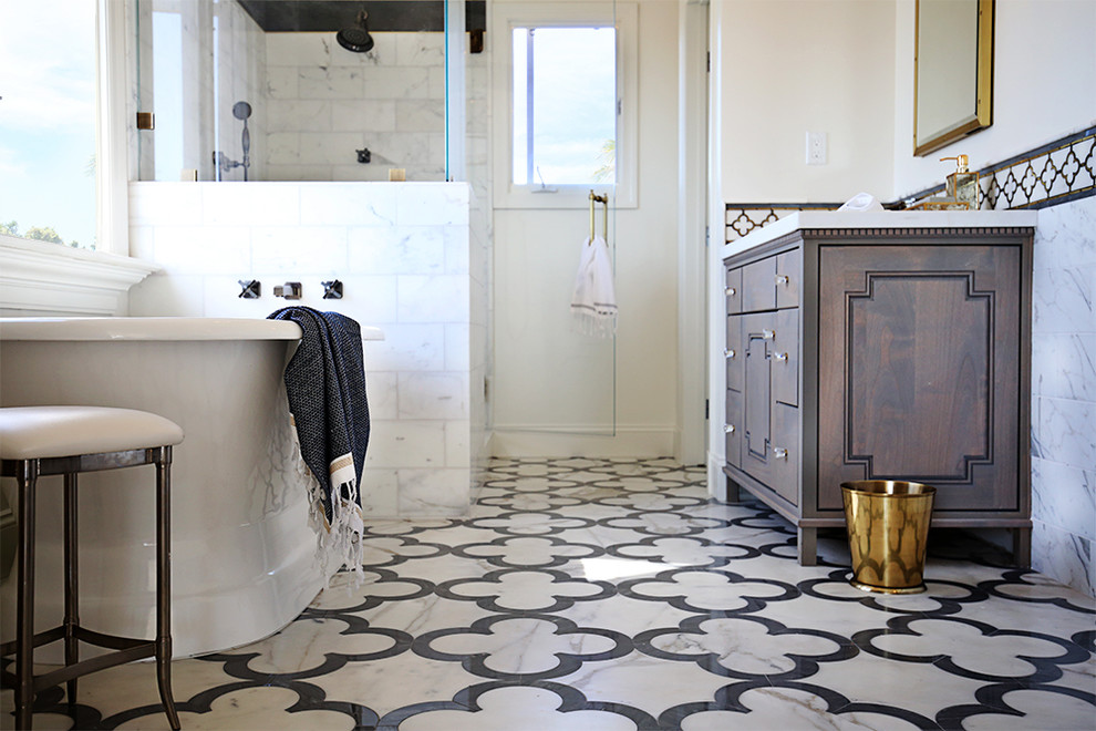 This is an example of a large traditional bathroom in San Diego with furniture-like cabinets, grey cabinets, a claw-foot tub, a corner shower, a one-piece toilet, white tile, stone tile, white walls, marble floors, an undermount sink and marble benchtops.