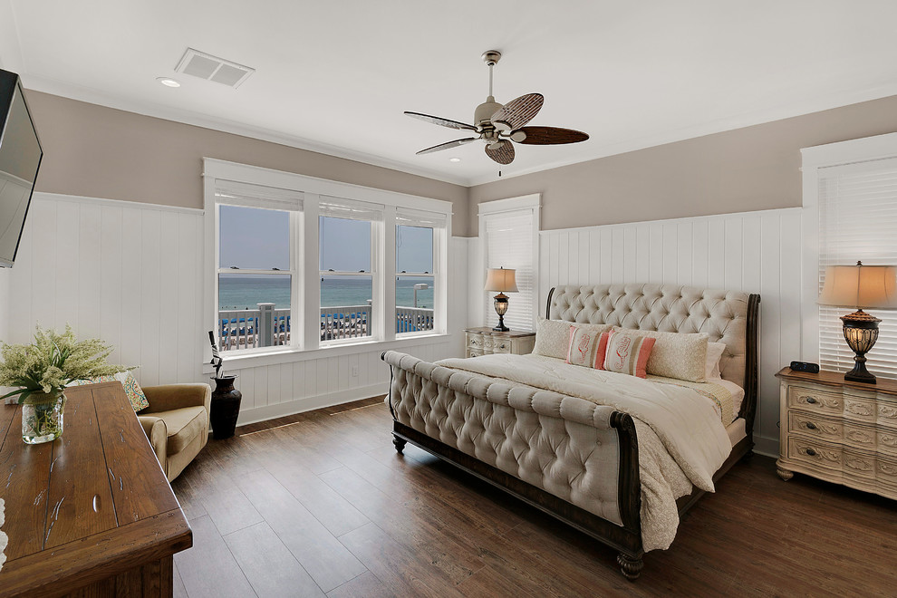 Design ideas for a mid-sized beach style master bedroom in Miami with beige walls, medium hardwood floors, no fireplace and brown floor.