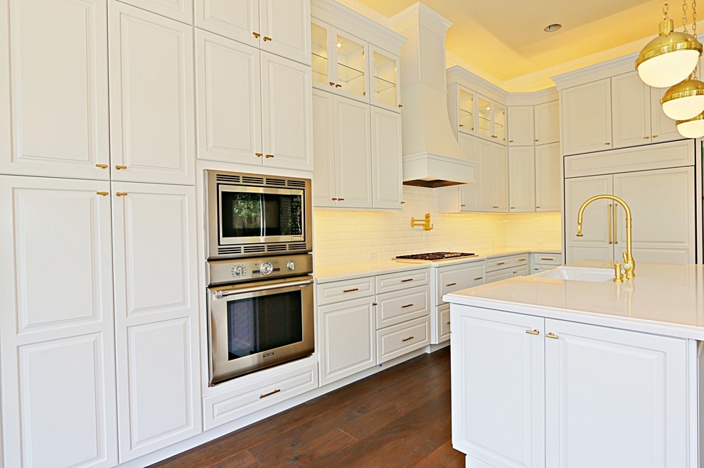 Inspiration for a transitional medium tone wood floor open concept kitchen remodel in Phoenix with white backsplash and an island