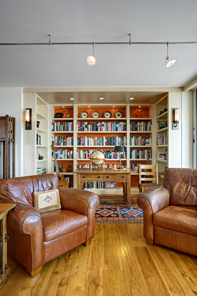 Inspiration for a mid-sized eclectic open concept living room in San Francisco with a library, white walls, medium hardwood floors, a built-in media wall and yellow floor.