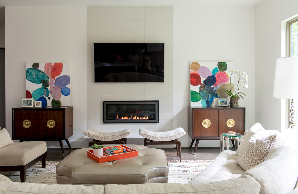 Inspiration for a large midcentury enclosed family room in Other with white walls, medium hardwood floors, no fireplace, a stone fireplace surround, a wall-mounted tv and brown floor.
