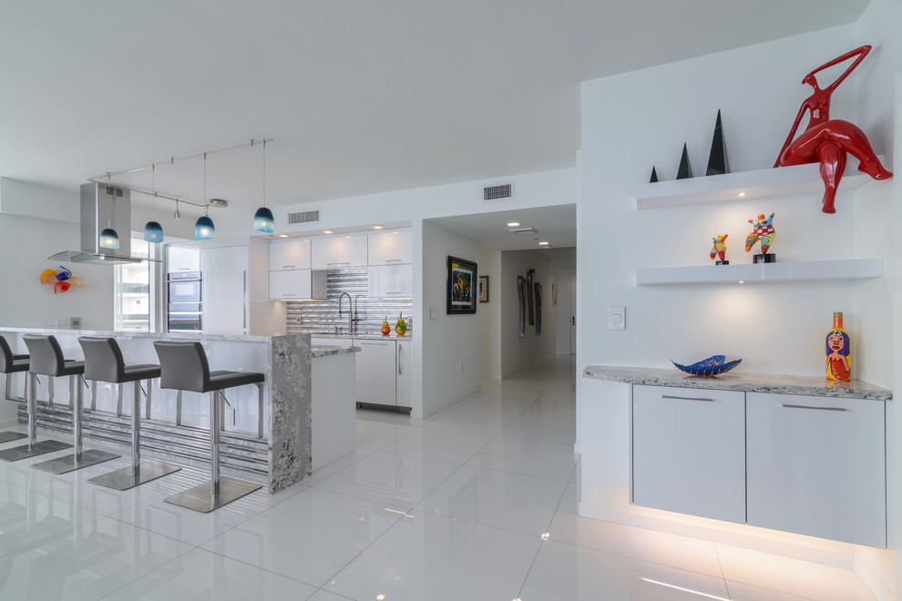 This is an example of a mid-sized modern galley separate kitchen in Miami with a single-bowl sink, flat-panel cabinets, white cabinets, quartz benchtops, metallic splashback, metal splashback, panelled appliances, porcelain floors, no island and white floor.