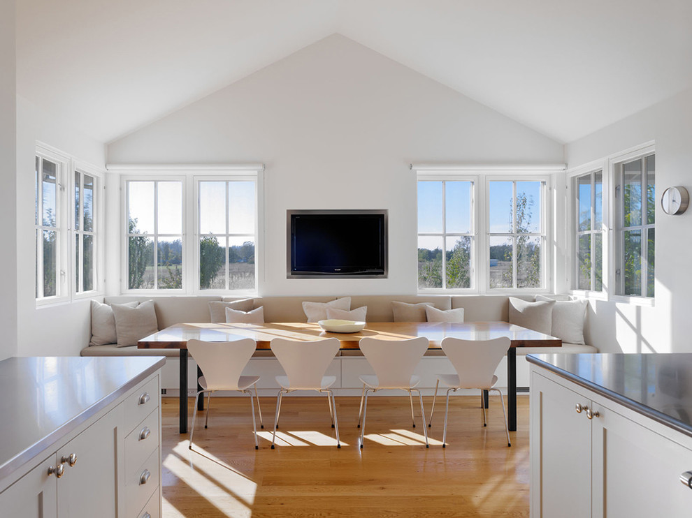 Photo of a transitional dining room in San Francisco with white walls and medium hardwood floors.