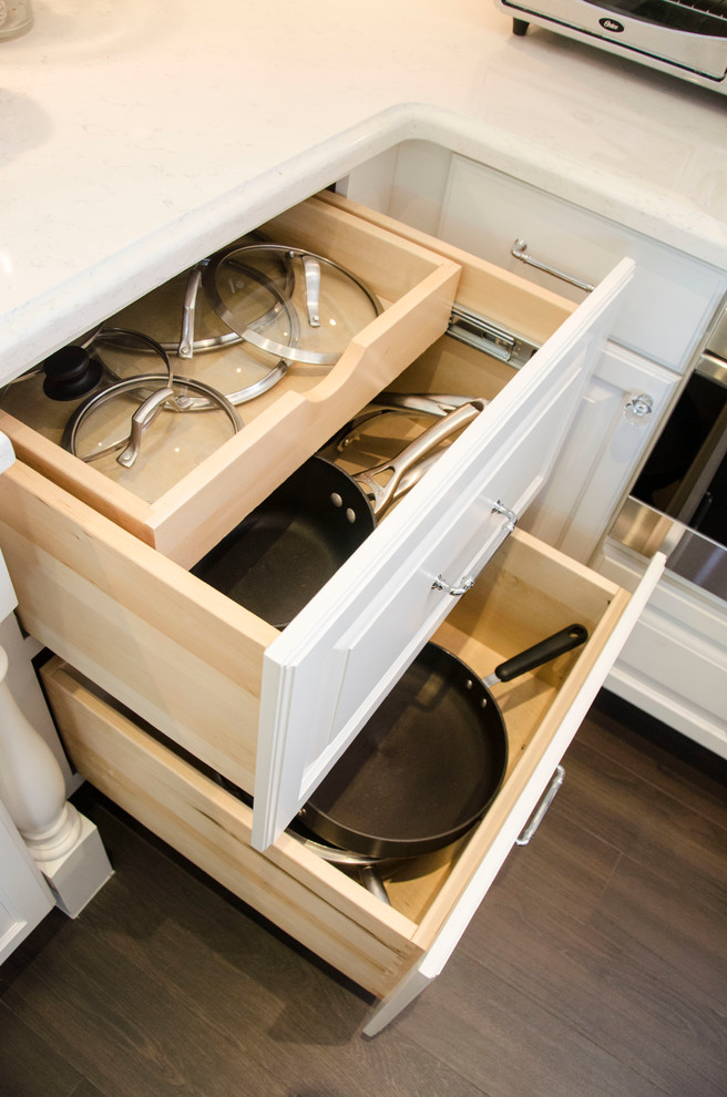 Enclosed kitchen - large transitional u-shaped enclosed kitchen idea in Miami with a farmhouse sink, raised-panel cabinets, white cabinets, quartz countertops, gray backsplash, porcelain backsplash, paneled appliances and an island