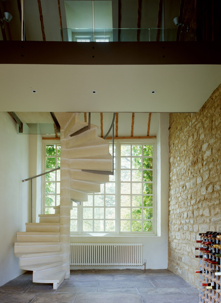 Mid-sized contemporary concrete spiral staircase in Oxfordshire with concrete risers and metal railing.