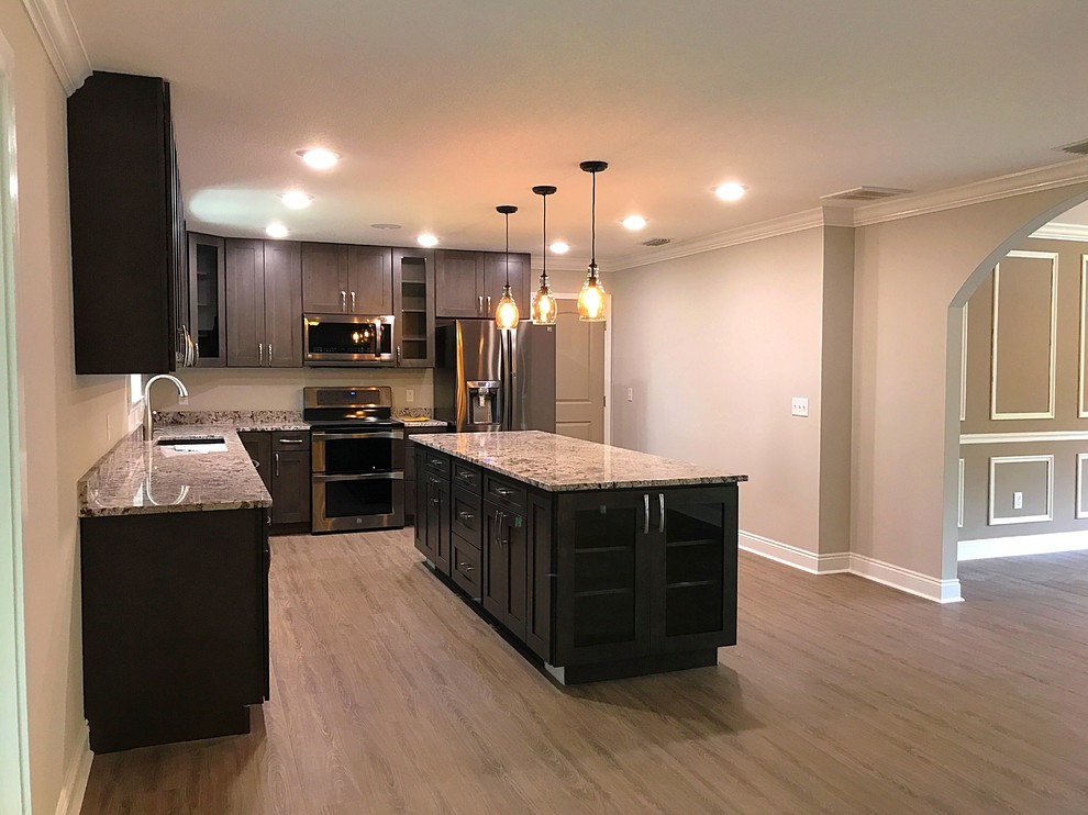 Inspiration for a large transitional l-shaped light wood floor and beige floor eat-in kitchen remodel with an undermount sink, shaker cabinets, dark wood cabinets, granite countertops, stainless steel appliances, an island and beige countertops
