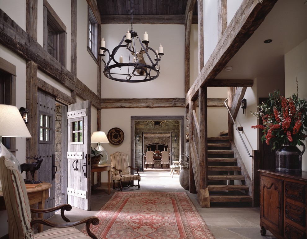 Country foyer in Other with white walls, a double front door and a medium wood front door.