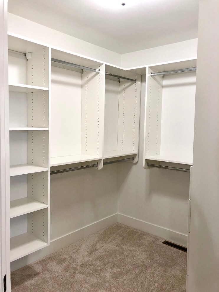 Large contemporary walk-in wardrobe in Other with open cabinets, white cabinets, carpet and beige floor.