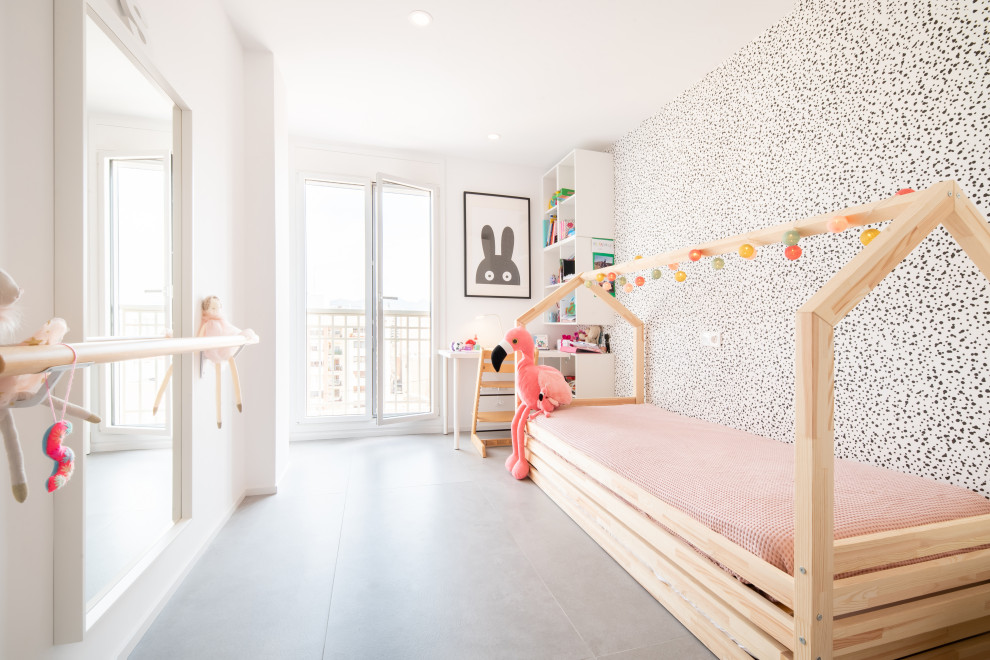 This is an example of a mid-sized modern kids' bedroom for girls in Other with white walls and grey floor.