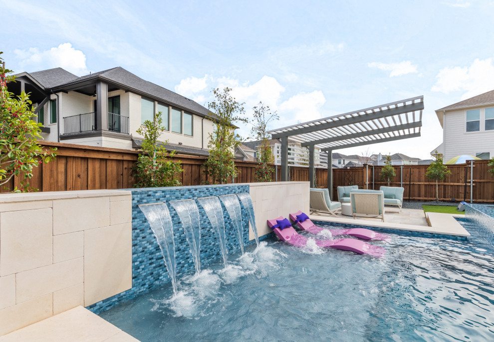 Inspiration for a mid-sized transitional backyard stone and custom-shaped pool remodel in Dallas
