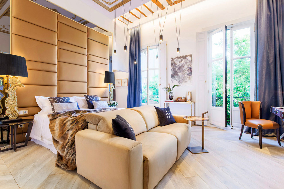Contemporary master bedroom in Madrid with plywood floors.