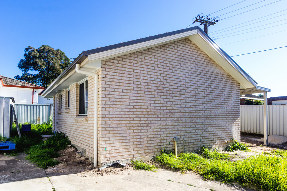 Inspiration for a small contemporary one-storey brick white exterior in Sydney.