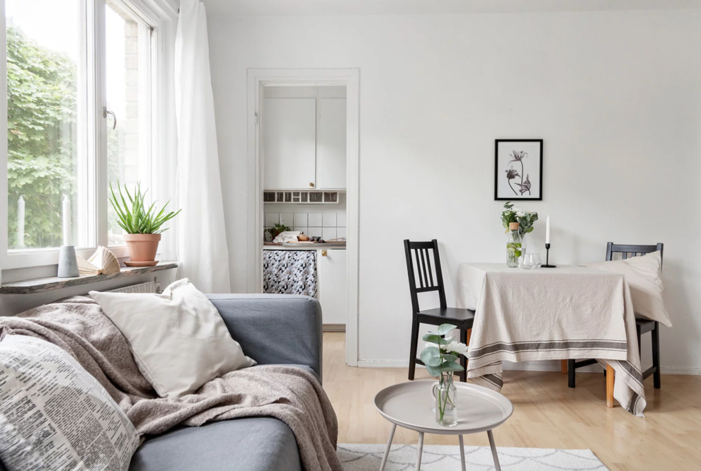 Inspiration for a small scandinavian open plan dining in Stockholm with white walls, light hardwood floors and beige floor.