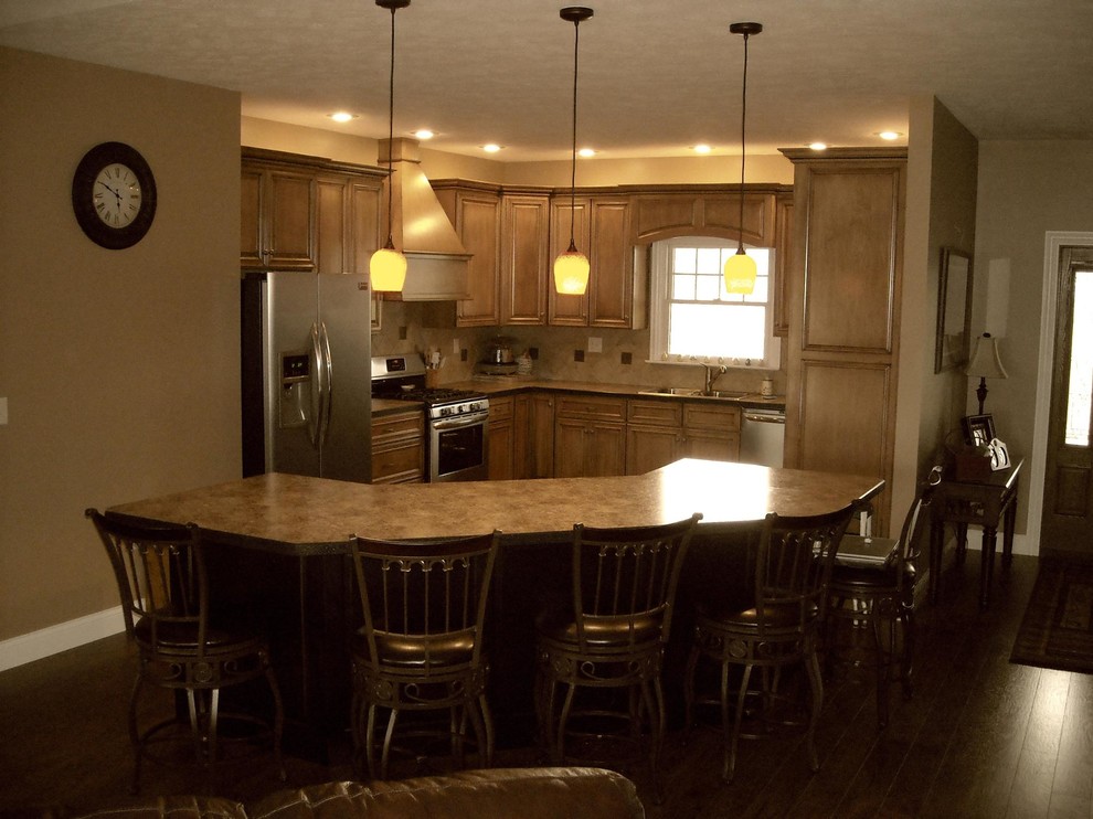 Enclosed kitchen - mid-sized transitional l-shaped dark wood floor enclosed kitchen idea in Columbus with a double-bowl sink, beaded inset cabinets, light wood cabinets, granite countertops, beige backsplash, stone tile backsplash, stainless steel appliances and an island