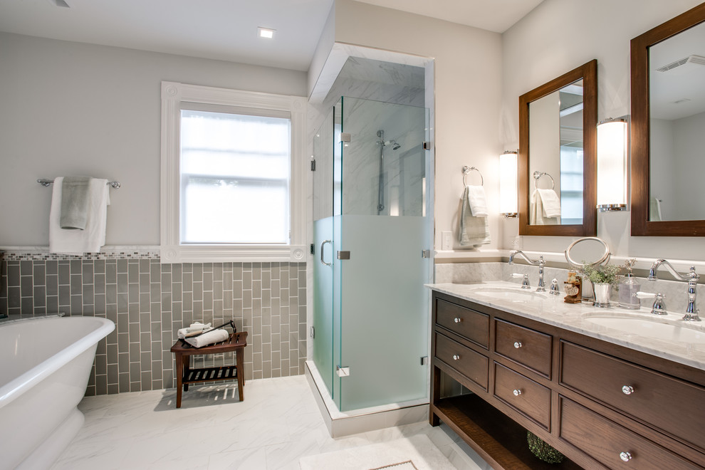 Traditional bathroom in Dallas with an undermount sink, recessed-panel cabinets, dark wood cabinets, a freestanding tub, an alcove shower, gray tile and subway tile.