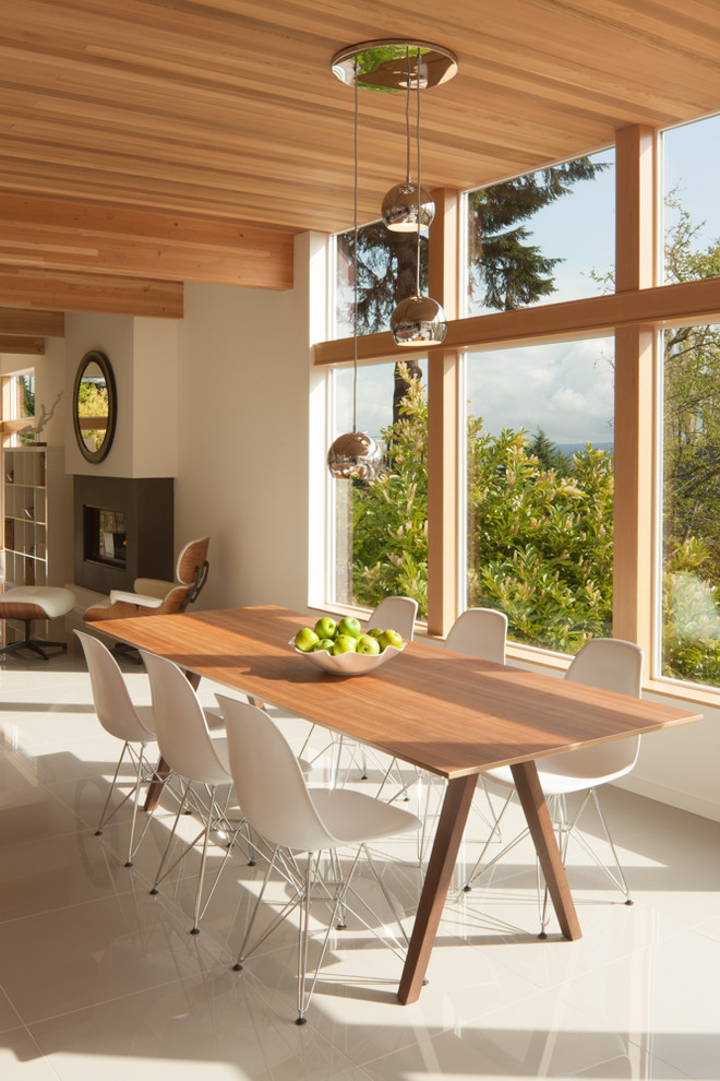 This is an example of a contemporary open plan dining in Seattle with white walls and ceramic floors.