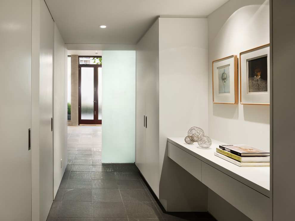 Modern hallway in San Francisco with white walls and grey floor.