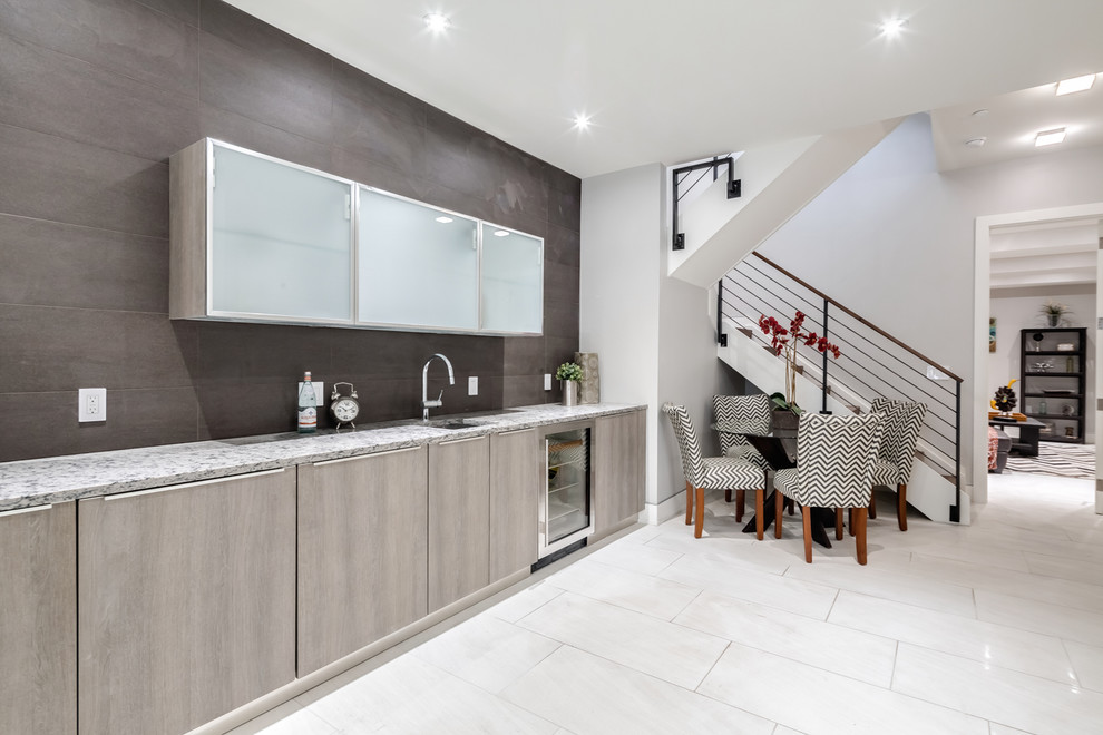 Large contemporary single-wall wet bar in Philadelphia with porcelain floors, white floor, an undermount sink, flat-panel cabinets, granite benchtops and grey cabinets.