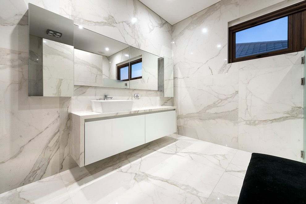 Inspiration for a mid-sized contemporary master bathroom in Perth with a vessel sink, white cabinets, marble benchtops, an open shower, white tile, porcelain tile, white walls and porcelain floors.